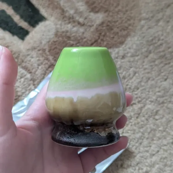 Ceramic whisk holder unboxed from dense foam packaging, photographed by a buyer