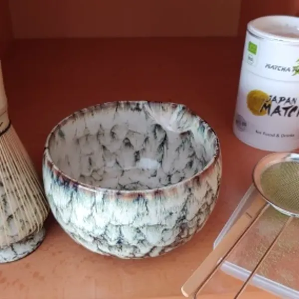 Seafoam green matcha bowl and tools in a customer fall table setting with pumpkins
