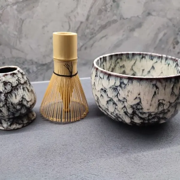 White 6-piece matcha set arranged on a concrete countertop — unedited customer photo